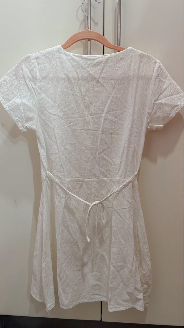 White Button-Up V-Neck Short Sleeve Mini Dress (Category: Dresses) located in Rizal. Submitted by shopiel (Listing ID 1446165388, Image 2). Description: 🔹PLEASE READ CAREFULLY BEFORE INQUIRING🔹 White Button-Up V-Neck Short Sleeve Mini Dress Size: Freesize but fits XS-Medium - Lightly used but like new! - Cute white mini dress - V-neck with button-up front - Short sleeves - Adjustable tie at the back to cinch the waist - Lightweight fabric, perf