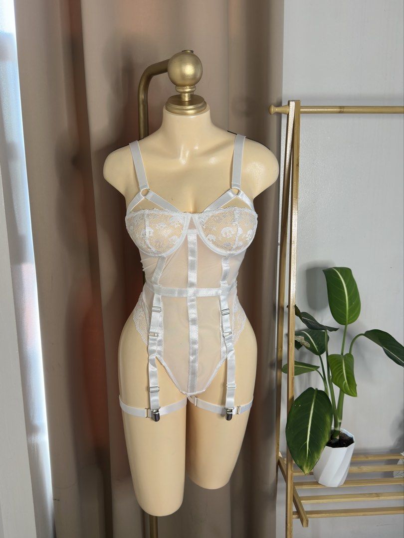 White Lace Strappy Bodysuit with Garters (Category: Undergarments & Loungewear) located in Angeles City. Submitted by xandra25 (Listing ID 1446302459, Image 1). Description: - Elegant white lace bodysuit - Features adjustable straps for a perfect fit - Includes garter clips for added styling options - Sheer lace cups with supportive underwire - Mesh body with delicate satin ribbon accents - Ideal for special occasions or as a layering piece.