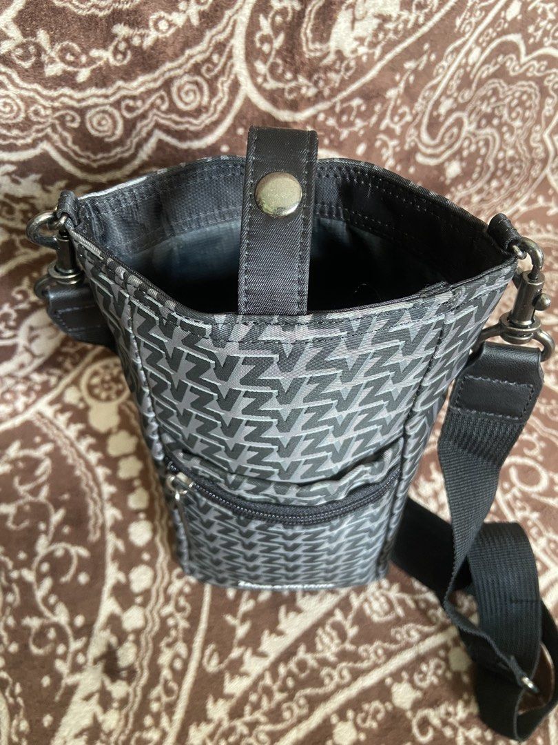 Zadig & Voltaire Monogram Crossbody Bag (Category: Luxury Bags & Wallets) located in Pili. Submitted by rgthriftflip29 (Listing ID 1446181956, Image 3). Description: - Zadig & Voltaire crossbody bag - All-over 'Z' monogram print - Zippered front pocket - Main compartment with snap closure - Adjustable strap - Ideal for on-the-go essentials - Durable material with reinforced base L:5” W:4” D:9” ☑️OVERALL EXCELLENT CONDI ❌ISSUE: MINIMAL SCRATCH ON 