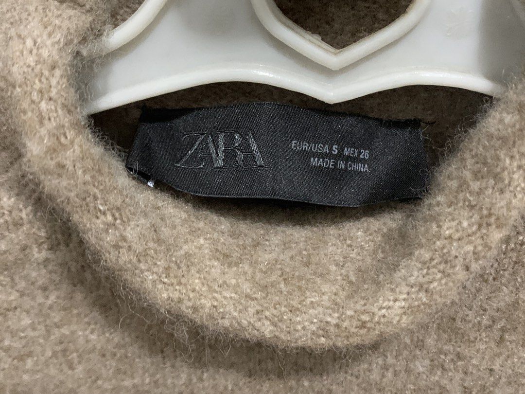 Zara Knit Top (Category: Others Tops) located in Marikina City. Submitted by pilloaf (Listing ID 1446286267, Image 2). Description: - Plain knit jumper with a high neck and short sleeves - In Light Mink color - Fits XS-S frames.