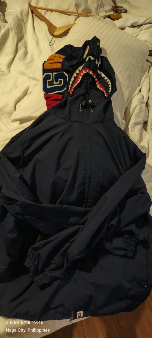 A Bathing Ape (BAPE) Shark Work Hoodie Jacket (Category: Coats, Jackets and Outerwear) located in Quezon City. Submitted by bry111 (Listing ID 1446468500, Image 1). Description: - Authentic Navy Blue A Bathing Ape Jacket - Features the iconic BAPE Shark graphic on the hood - Material: 100% Nylon - Very Good Condition - Ideal for layering - Manufactured by Nowhere Co., Ltd..