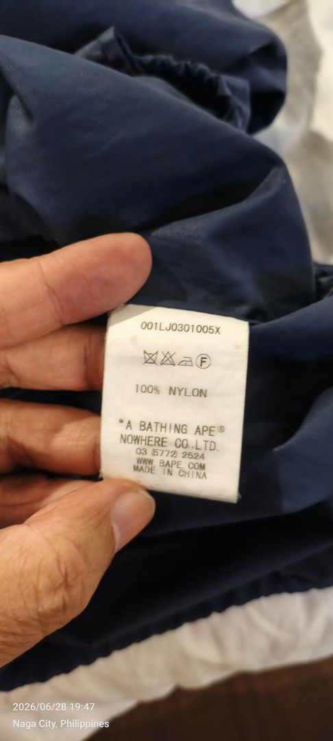 A Bathing Ape (BAPE) Shark Work Hoodie Jacket (Category: Coats, Jackets and Outerwear) located in Quezon City. Submitted by bry111 (Listing ID 1446468500, Image 2). Description: - Authentic Navy Blue A Bathing Ape Jacket - Features the iconic BAPE Shark graphic on the hood - Material: 100% Nylon - Very Good Condition - Ideal for layering - Manufactured by Nowhere Co., Ltd..