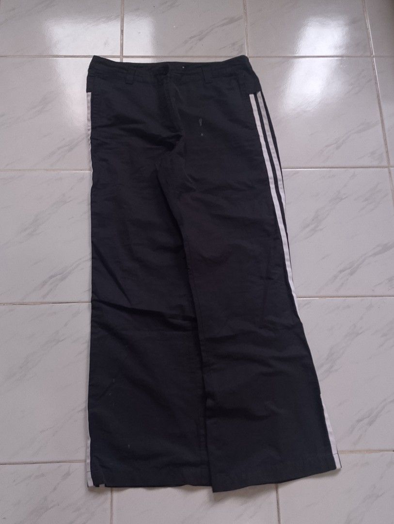 Adidas Black Track Pants with White Stripes (Category: Other Bottoms) located in Buhi. Submitted by fpthrift1 (Listing ID 1446487743, Image 1). Description: - Classic black Adidas track pants - Iconic three white stripes down the sides - Drawstring waist for a comfortable fit - Adidas logo on the leg - Versatile for sports or casual wear - Size: Large (L).