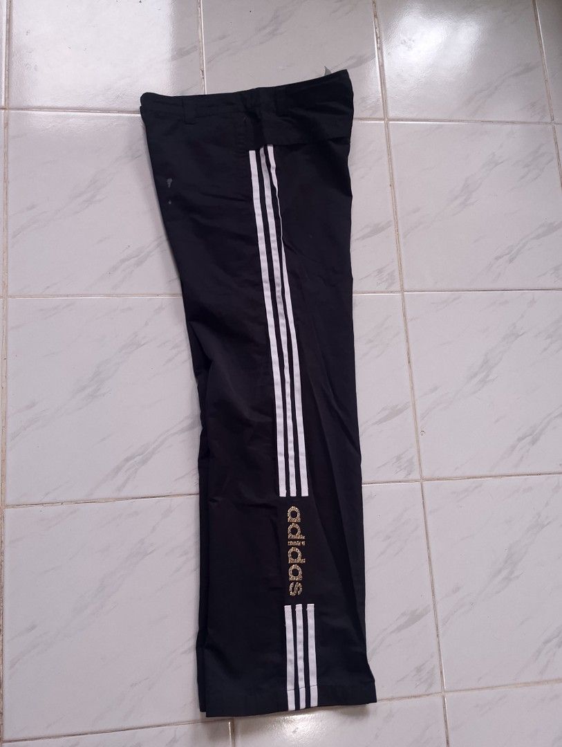 Adidas Black Track Pants with White Stripes (Category: Other Bottoms) located in Buhi. Submitted by fpthrift1 (Listing ID 1446487743, Image 3). Description: - Classic black Adidas track pants - Iconic three white stripes down the sides - Drawstring waist for a comfortable fit - Adidas logo on the leg - Versatile for sports or casual wear - Size: Large (L).