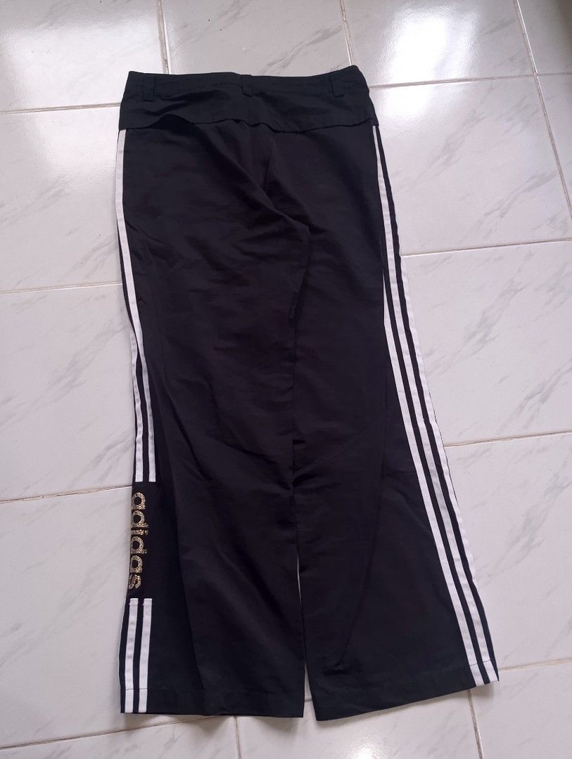 Adidas Black Track Pants with White Stripes (Category: Other Bottoms) located in Buhi. Submitted by fpthrift1 (Listing ID 1446487743, Image 2). Description: - Classic black Adidas track pants - Iconic three white stripes down the sides - Drawstring waist for a comfortable fit - Adidas logo on the leg - Versatile for sports or casual wear - Size: Large (L).