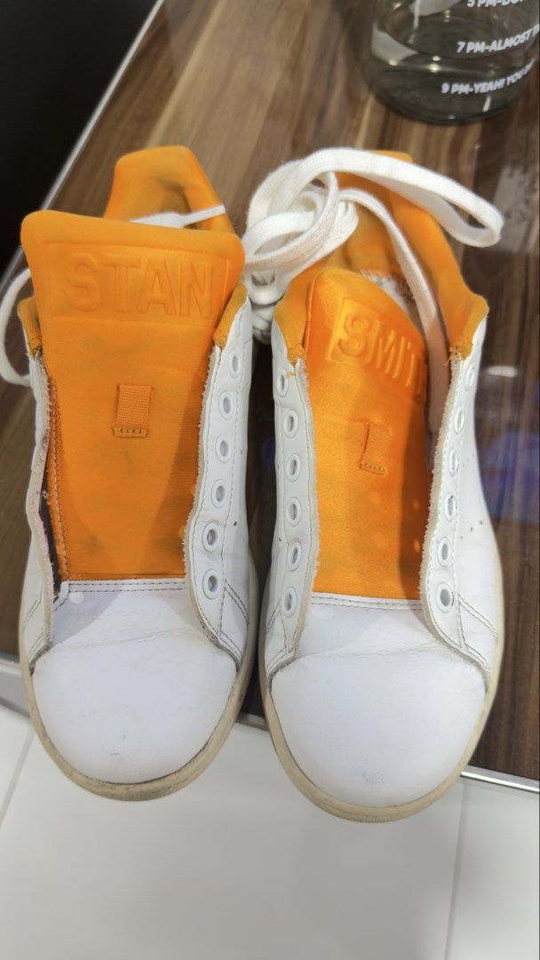 Adidas Stan Smith White Orange Leather Sneakers (Category: Sneakers) located in Quezon City. Submitted by delideclutters (Listing ID 1446513915, Image 2). Description: - Classic Adidas Stan Smith sneakers - White leather with orange heel tab and tongue accents - Iconic Stan Smith branding - Soles show some wear but have plenty of grip - Laces included - Perfect for casual wear.