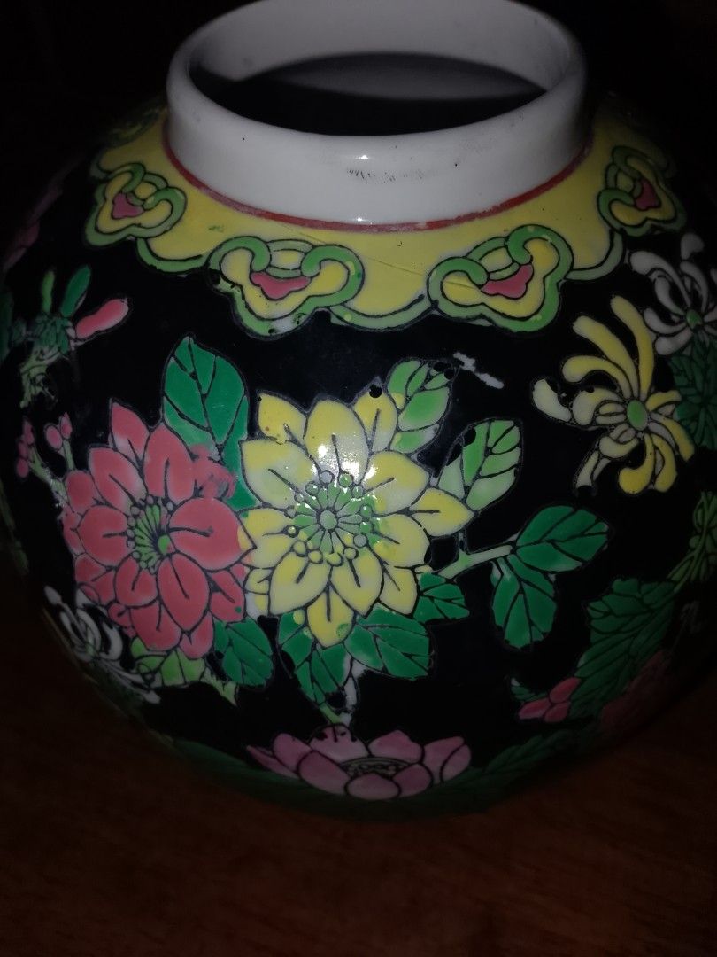 Antique Chinese Ginger Jar (Category: Vases & Decorative Bowls) located in Simpang. Submitted by desoul8867 (Listing ID 1446518269, Image 3). Description: - Elegant ceramic vase with a sturdy black base. - Adorned with colorful lotus flowers and chrysanthemums. - Features a unique yellow cloud pattern around the neck. - Stands approximately 6 inches tall. - Ideal for enhancing your home decor or as a thoughtful gift..