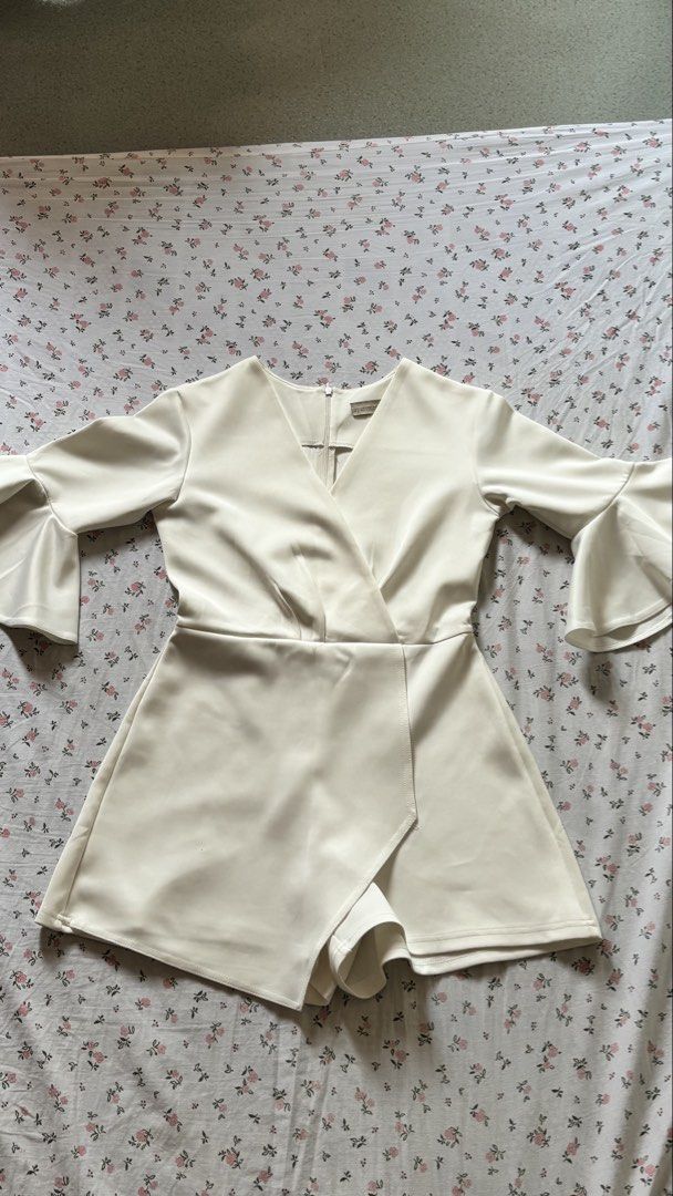 Apartment Eight White Bell Sleeve Wrap Playsuit (Category: Rompers) located in Lucban. Submitted by ogchic (Listing ID 1446355537, Image 1). Description: - White playsuit from Apartment Eight - Features a flattering wrap front - Stylish bell sleeves - Zipper closure at the back - Best fits size S - Ideal for parties or a night out.