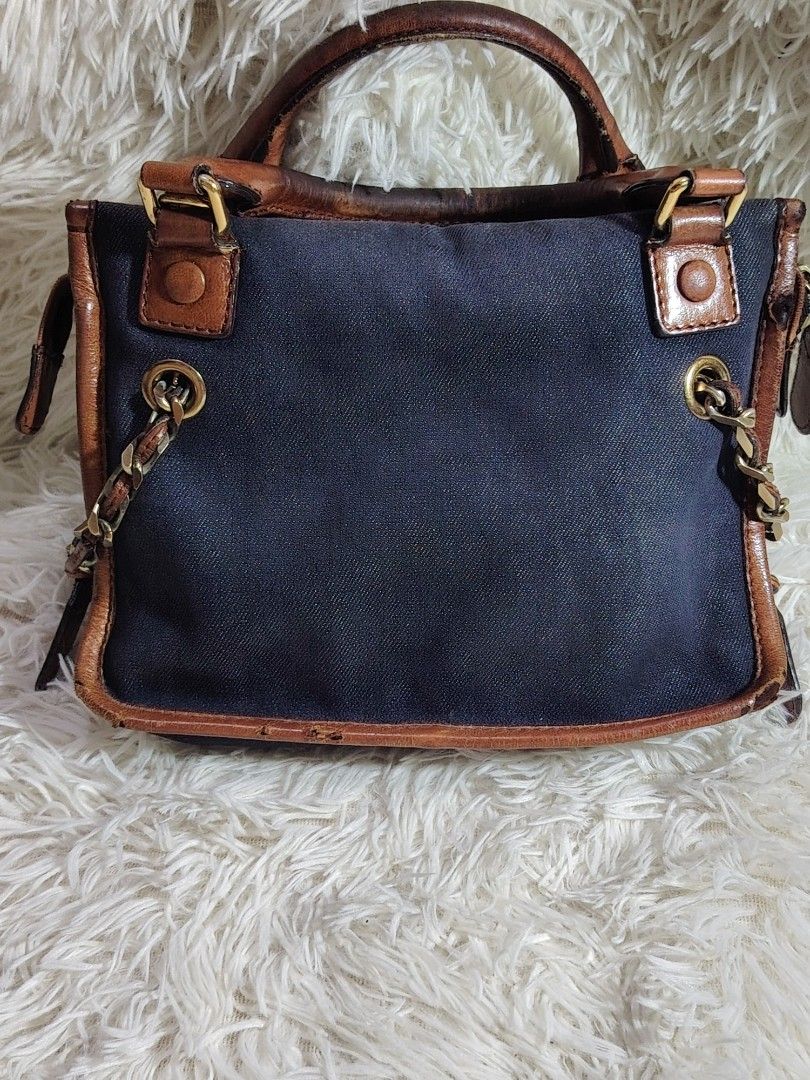 AUTHENTIC VINTAGE Chloe denim canvas bag y2k (Category: Luxury Bags & Wallets) located in Bulacan. Submitted by shell_23 (Listing ID 1446511053, Image 2). Description: - Dark blue canvas handbag - Brown leather trim - Chain detail on sides and handles - Embossed Chloe logo on front leather patch - with hologram -all metal accessories in good condition -visible leather issue need repair or restoration -denim canvass excellent condition need clean 