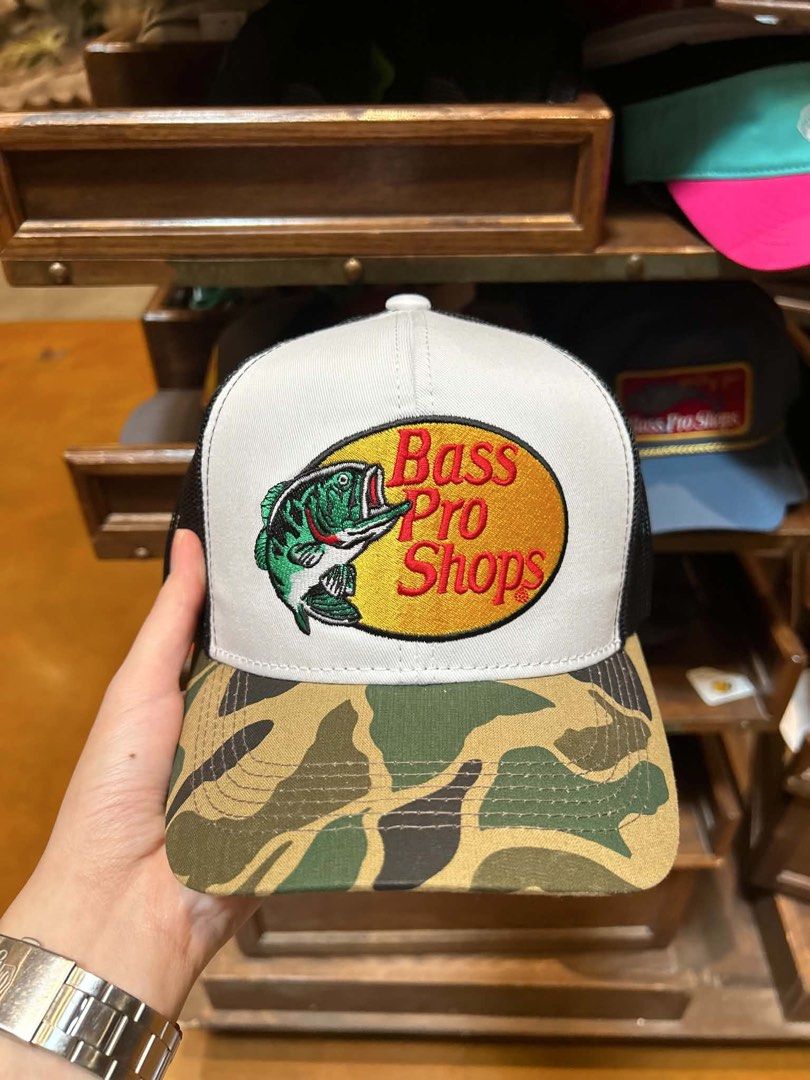Bass Pro Shops Trucker Hat - Camo Brim (Category: Caps & Hats) located in San Pablo. Submitted by noahcabrer45248 (Listing ID 1446395099, Image 1). Description: - Classic Bass Pro Shops trucker hat - Features iconic fish logo on the front - White front panel with black mesh back - Cool camouflage pattern on the brim - Adjustable snapback closure for a comfortable fit - Perfect for fishing and outdoor enthusiasts.