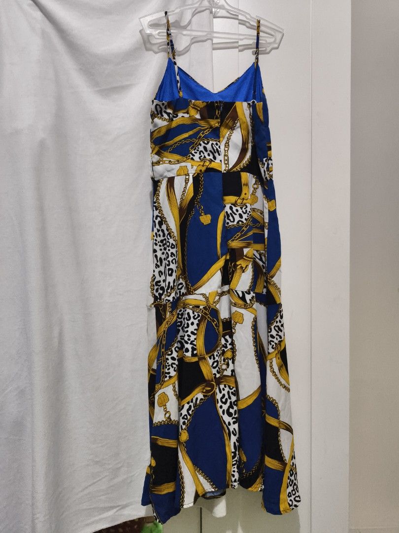 Blue Chain Print Spaghetti Strap Midi Dress (Category: Dresses) located in Muntinlupa City. Submitted by cozmovingout (Listing ID 1446490284, Image 2). Description: - Midi dress with spaghetti straps and V-neckline. - Eye-catching print: Bold chain and leopard pattern. - Colors: Blue, white, black, and gold. - Comfortable for warmer weather. - Versatile for casual outings or nights out..