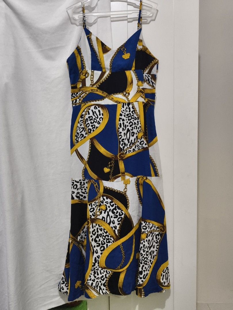 Blue Chain Print Spaghetti Strap Midi Dress (Category: Dresses) located in Muntinlupa City. Submitted by cozmovingout (Listing ID 1446490284, Image 1). Description: - Midi dress with spaghetti straps and V-neckline. - Eye-catching print: Bold chain and leopard pattern. - Colors: Blue, white, black, and gold. - Comfortable for warmer weather. - Versatile for casual outings or nights out..