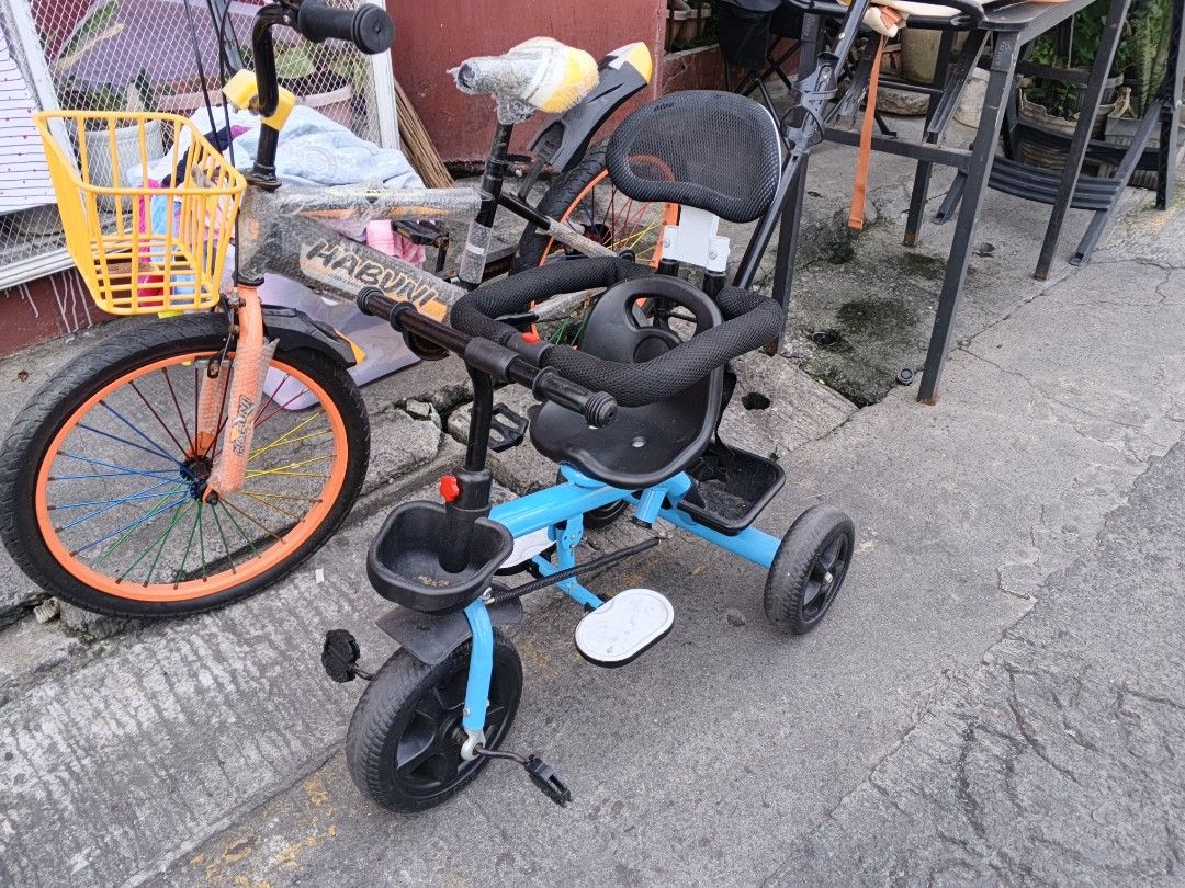 Blue Tricycle with Parent Handle and Basket (Category: Motorbikes for Sale) located in Manila. Submitted by LUXxYQueen (Listing ID 1446437472, Image 2). Description: Blue tricycle for kids. Has a parent push handle at the back. Also includes a yellow basket at the front. Footrests are attached. Ready for a new owner. Great for outdoor fun..