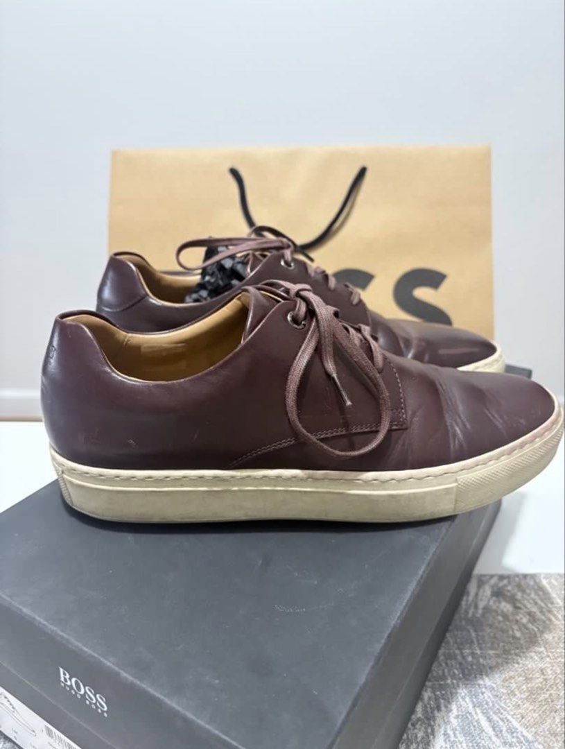 BOSS Brown Leather Lace-Up Sneakers (Category: Sneakers) located in Valenzuela. Submitted by kat_preloveditems (Listing ID 1446496639, Image 2). Description: - Original BOSS Brown Leather Sneakers -Made in Italy - Classic lace-up style - Durable rubber sole - Ideal for casual wear - Comes with original box and paper bag - Minor scuffs on soles and leather (expected with use) MOP: Gcash QC Vertis area SF c/o buyer via lalamove or J&T.
