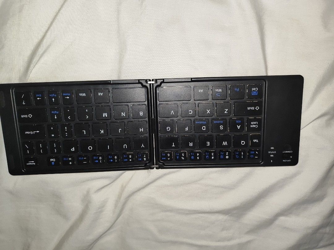 (BROKEN) Bluetooth Foldable Keyboard -NOT WORKING FOR SPARE PARTS (Category: Computer Keyboard) located in Antipolo. Submitted by frost.bite (Listing ID 1446464221, Image 1). Description: BROKEN / NOT WORKING / FOR SPARE PARTS - Lights up when charged (type C) - Shuts down and doesn't work. - Missing Screws.