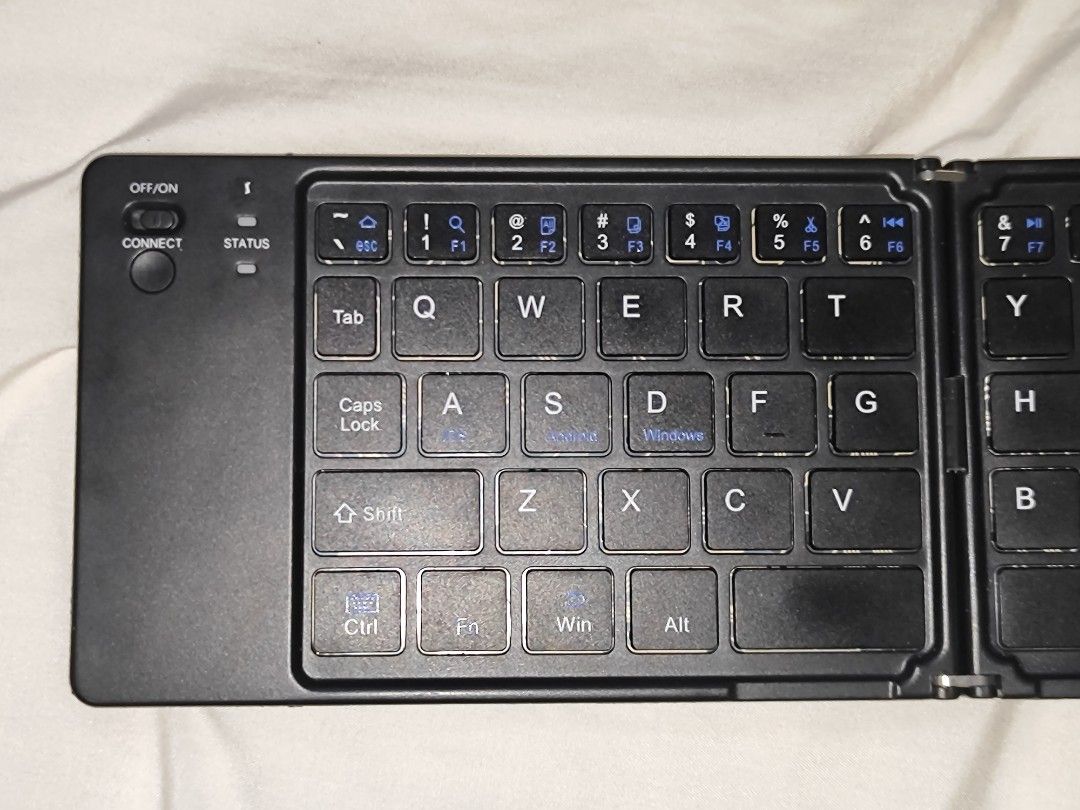 (BROKEN) Bluetooth Foldable Keyboard -NOT WORKING FOR SPARE PARTS (Category: Computer Keyboard) located in Antipolo. Submitted by frost.bite (Listing ID 1446464221, Image 3). Description: BROKEN / NOT WORKING / FOR SPARE PARTS - Lights up when charged (type C) - Shuts down and doesn't work. - Missing Screws.