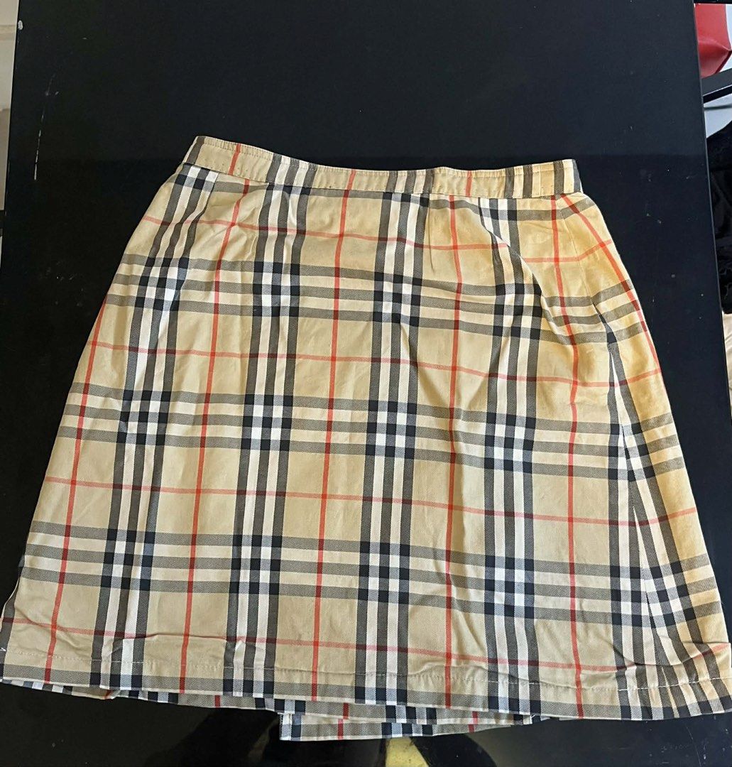 Burberrys Nova Check Wrap Skirt Size L (Category: Luxury Apparel) located in Meycauayan. Submitted by venelyngum56325 (Listing ID 1446389343, Image 3). Description: - Classic Burberrys Nova Check Wrap Skirt - Size: Large (L) - Features the iconic Burberry check pattern - Side button closure for a secure fit - Versatile for casual or smart casual outfits - A timeless addition to your wardrobe.