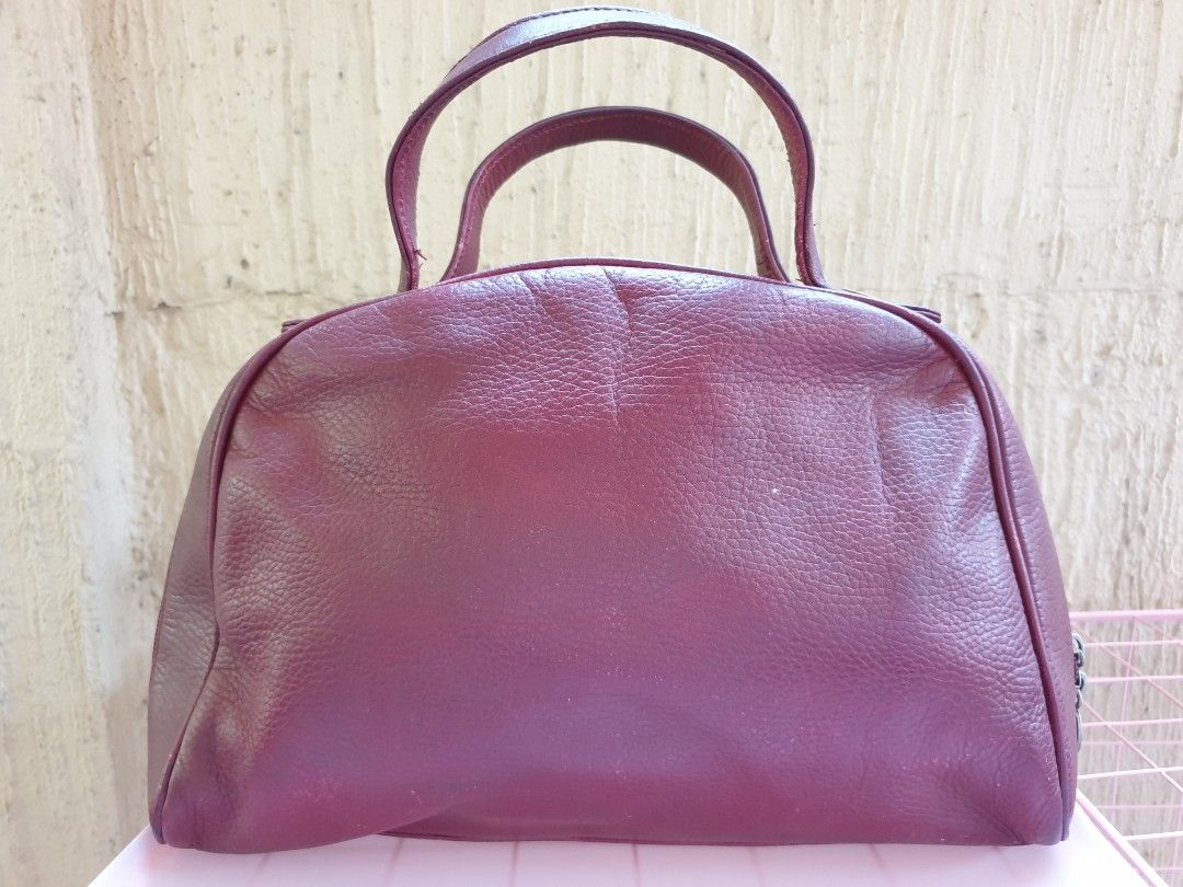 Cartier Burgundy Leather Handbag (Category: Luxury Bags & Wallets) located in Las Pinas. Submitted by anggesmart (Listing ID 1446412101, Image 2). Description: - Authentic Must de Cartier burgundy leather handbag - Iconic embossed double C logo on the front - Secure zipper closure with Cartier branded hardware - Interior lining features a repeating Cartier logo pattern - Minor scuffs visible on the corners - A classic and elegant addition to any 