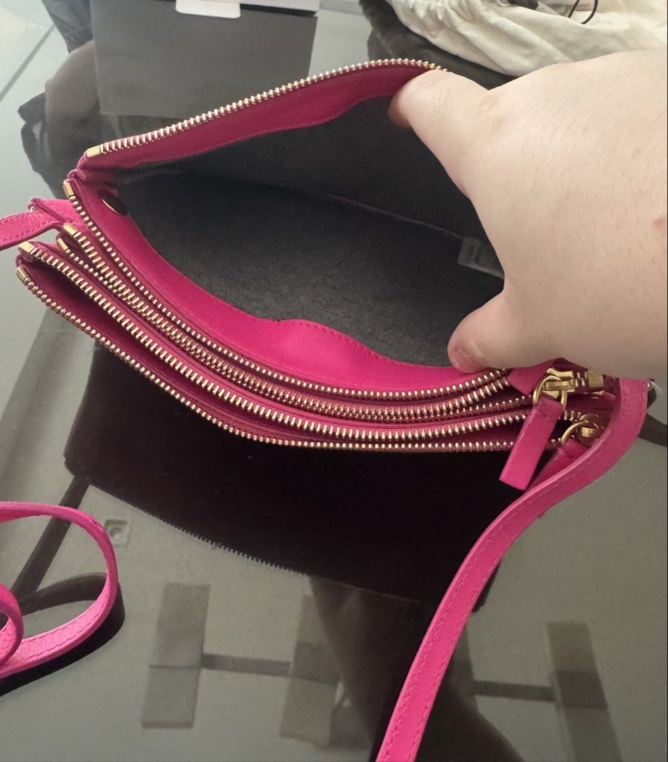 Celine Trio Large in Barbie Pink (Category: Luxury Bags & Wallets) located in Mandaluyong City. Submitted by declutteringmylife101 (Listing ID 1446373509, Image 3). Description: - Authentic Celine pouch bag - Vibrant pink genuine leather - Multiple zippered compartments for organization - Adjustable strap - Gold hardware details - Perfect for essentials.