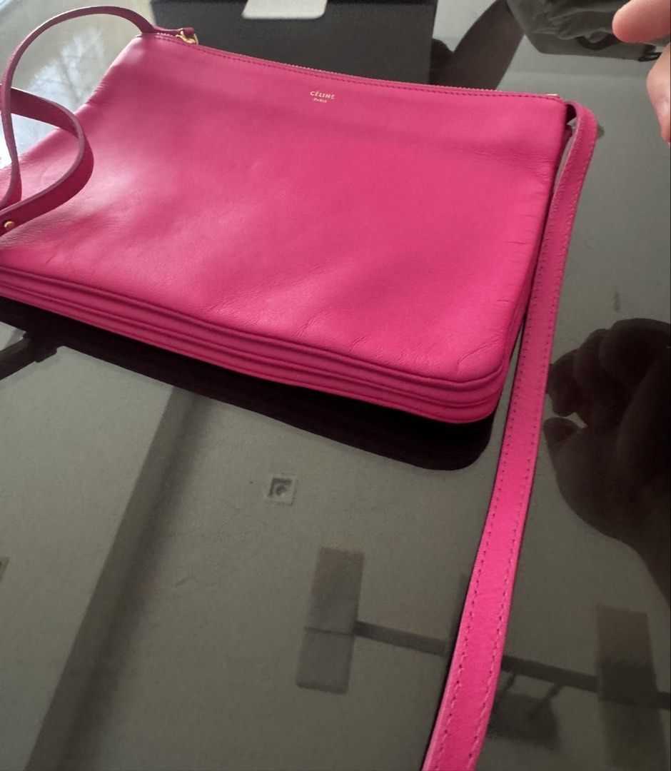 Celine Trio Large in Barbie Pink (Category: Luxury Bags & Wallets) located in Mandaluyong City. Submitted by declutteringmylife101 (Listing ID 1446373509, Image 2). Description: - Authentic Celine pouch bag - Vibrant pink genuine leather - Multiple zippered compartments for organization - Adjustable strap - Gold hardware details - Perfect for essentials.