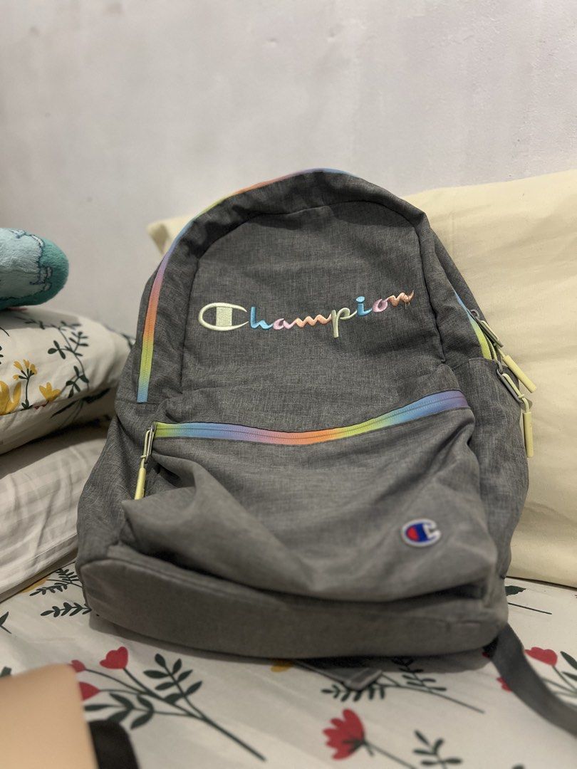 Champion Grey Backpack with Rainbow Accents (Category: Backpacks) located in Pasig City. Submitted by pabsssssssssss (Listing ID 1446442516, Image 1). Description: -Classic Grey Champion backpack (FIXED PRICE) - Features iconic colorful embroidered Champion logo - Stylish rainbow stripe detail along the zipper - Two spacious main compartments - Convenient side pockets for extra storage - Adjustable padded straps for maximum comfort - Ideal for sc