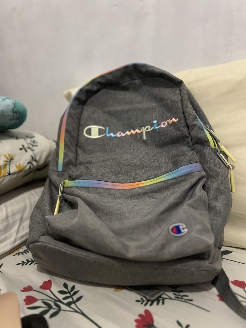 Champion Grey Backpack with Rainbow Accents (Category: Backpacks) located in Pasig City. Submitted by pabsssssssssss (Listing ID 1446442516, Image 2). Description: -Classic Grey Champion backpack (FIXED PRICE) - Features iconic colorful embroidered Champion logo - Stylish rainbow stripe detail along the zipper - Two spacious main compartments - Convenient side pockets for extra storage - Adjustable padded straps for maximum comfort - Ideal for sc