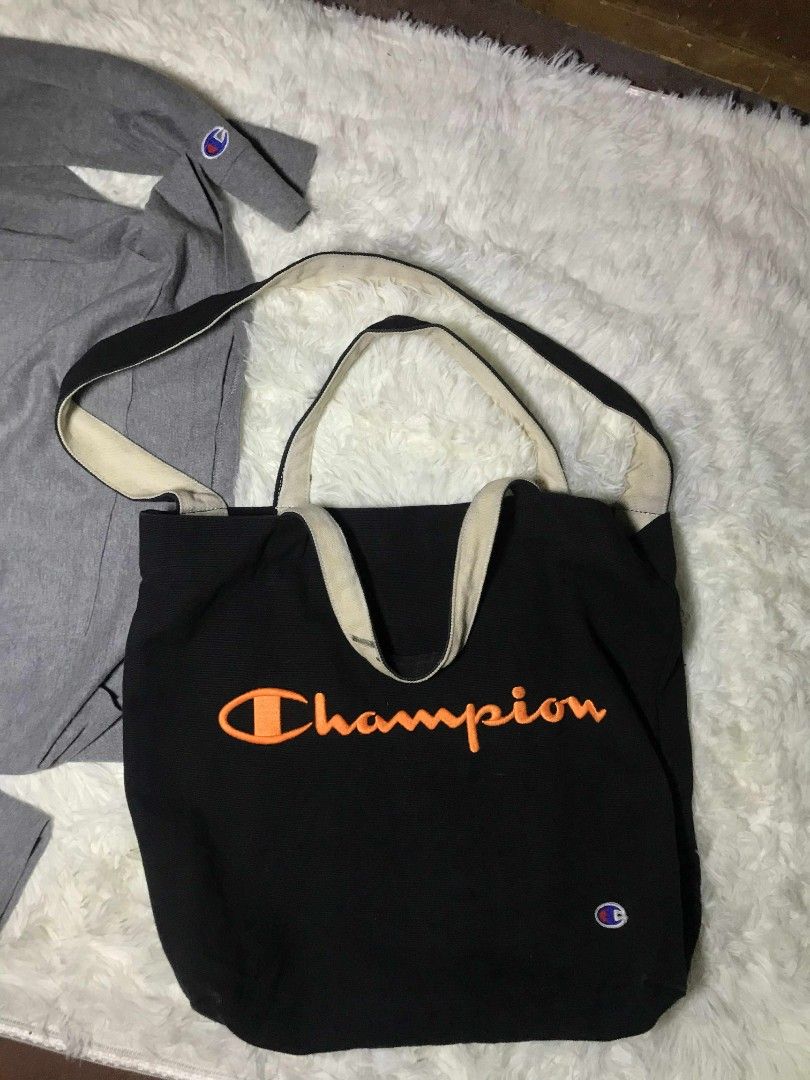 Champion Tote Bag Black Orange Logo (Category: Tote Bags) located in Manila. Submitted by ronmark (Listing ID 1446379321, Image 2). Description: - Classic black Champion tote bag - Iconic embroidered orange logo on front - Neutral beige straps - Ideal for everyday use, books, or groceries - Simple and durable design.