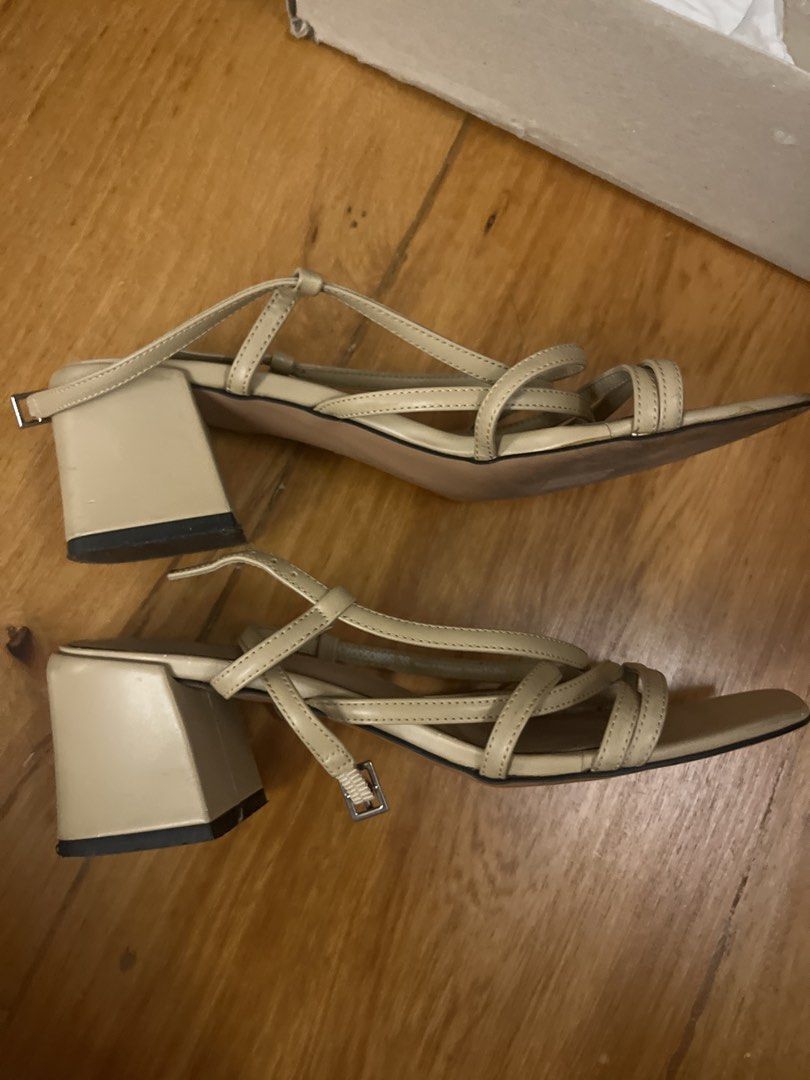 Charles & Keith Beige Strappy Heeled Sandals (Category: Heels) located in Mandaluyong City. Submitted by closet.secrets (Listing ID 1446503619, Image 2). Description: - Brand: Charles & Keith - Color: Neutral Beige - Design: Delicate ankle straps - Heel: Low heel for comfort - Toe: Square toe - Versatility: Great for dressing up or down.