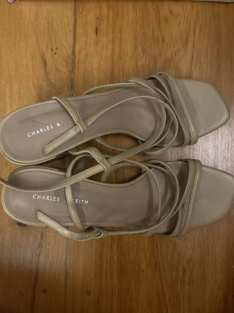 Charles & Keith Beige Strappy Heeled Sandals (Category: Heels) located in Mandaluyong City. Submitted by closet.secrets (Listing ID 1446503619, Image 1). Description: - Brand: Charles & Keith - Color: Neutral Beige - Design: Delicate ankle straps - Heel: Low heel for comfort - Toe: Square toe - Versatility: Great for dressing up or down.