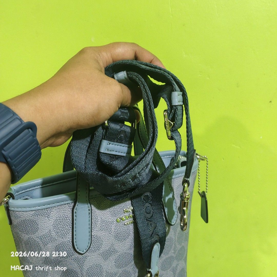 Coach Monogram Mini Tote Bag (Category: Luxury Bags & Wallets) located in Quezon City. Submitted by macaj_thrift_shop2 (Listing ID 1446496951, Image 3). Description: NO COD‼️ PAYMENT FIRST POLICY LAST PRICE POSTED, ASKING FOR LAST PRICE WILL NOT BE ENTERTAINED. - Authentic Coach mini tote bag - Signature grey and blue monogram pattern - Genuine leather trim and handles - Secure zipper closure - Detachable crossbody strap included - Compact size, 
