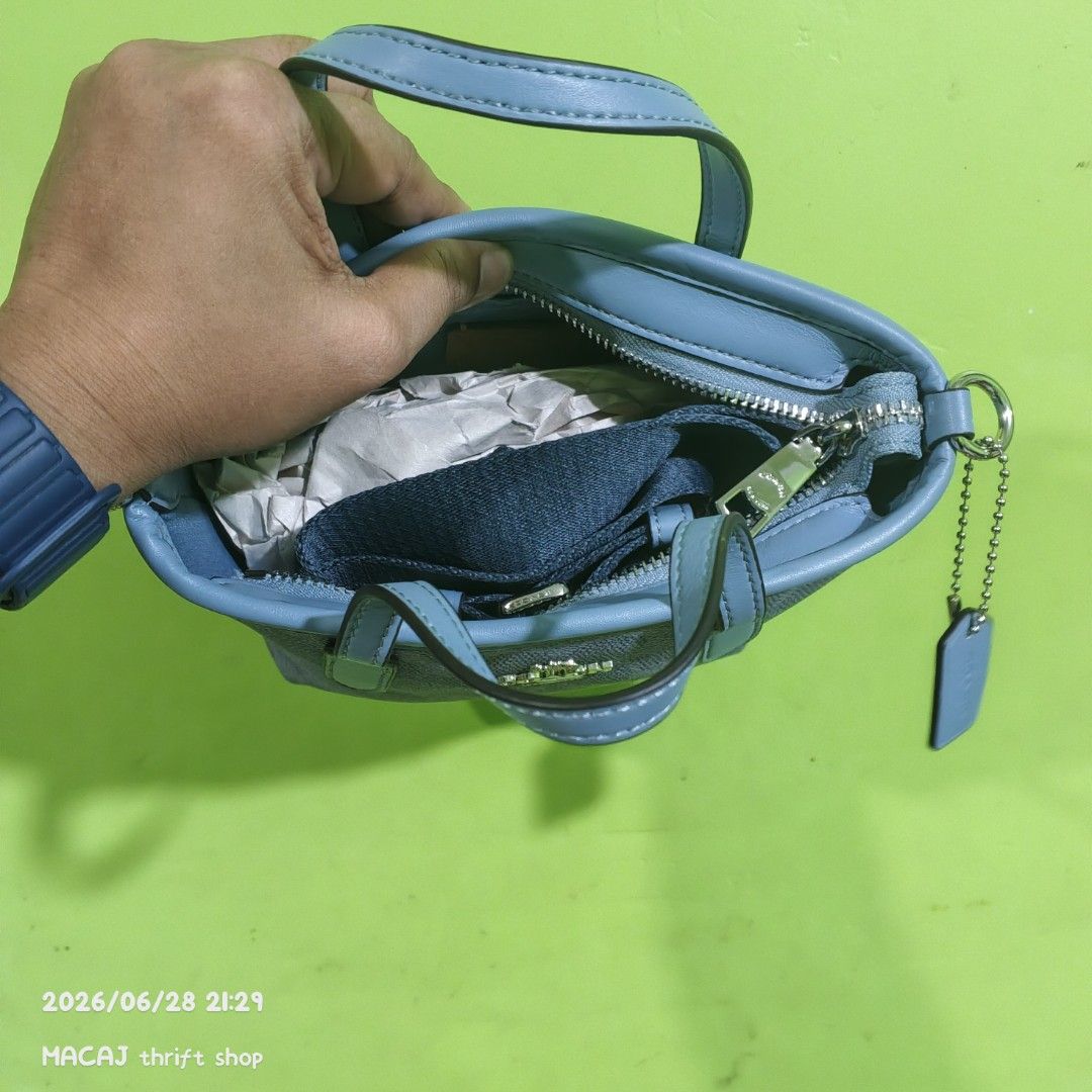 Coach Monogram Mini Tote Bag (Category: Luxury Bags & Wallets) located in Quezon City. Submitted by macaj_thrift_shop2 (Listing ID 1446496951, Image 2). Description: NO COD‼️ PAYMENT FIRST POLICY LAST PRICE POSTED, ASKING FOR LAST PRICE WILL NOT BE ENTERTAINED. - Authentic Coach mini tote bag - Signature grey and blue monogram pattern - Genuine leather trim and handles - Secure zipper closure - Detachable crossbody strap included - Compact size, 
