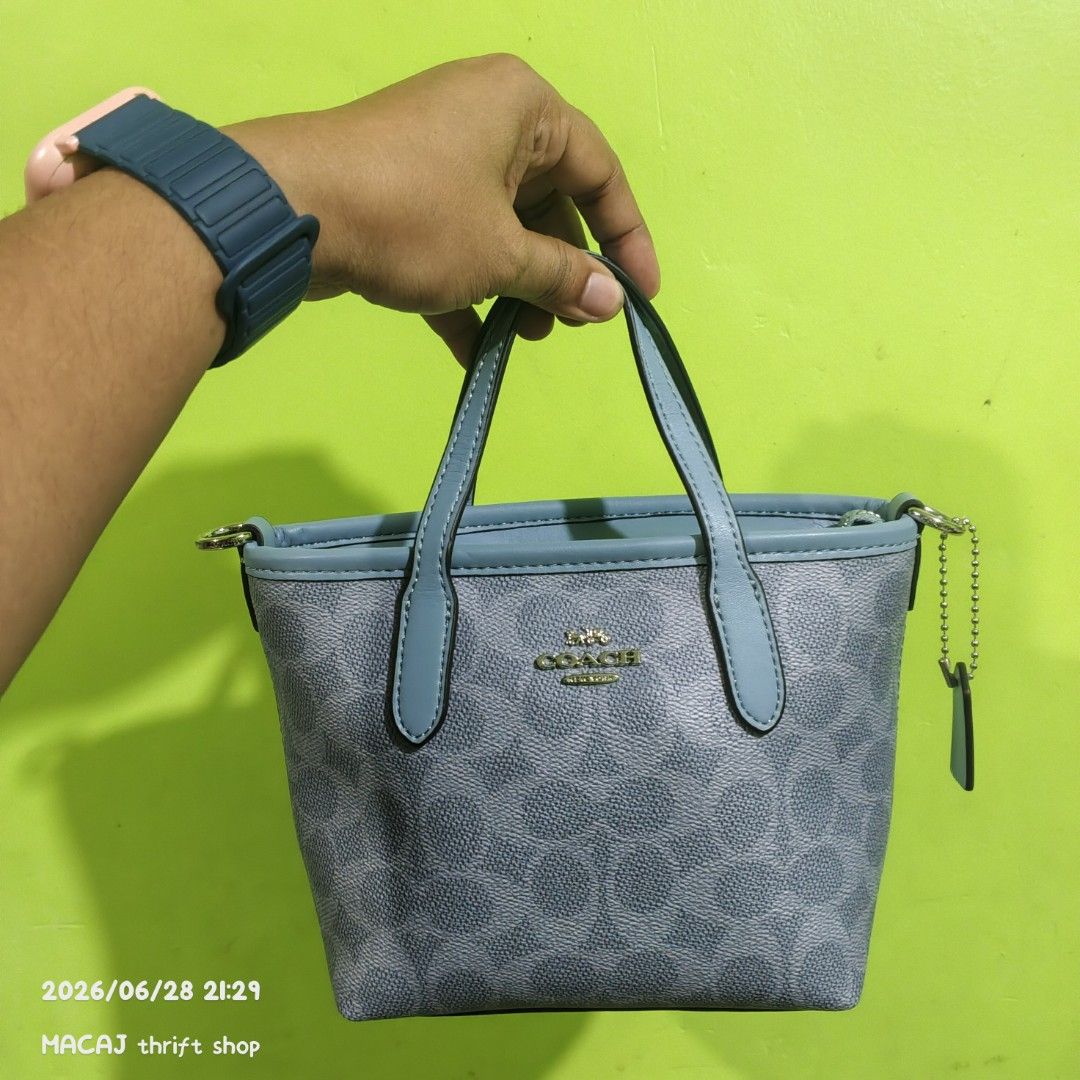 Coach Monogram Mini Tote Bag (Category: Luxury Bags & Wallets) located in Quezon City. Submitted by macaj_thrift_shop2 (Listing ID 1446496951, Image 1). Description: NO COD‼️ PAYMENT FIRST POLICY LAST PRICE POSTED, ASKING FOR LAST PRICE WILL NOT BE ENTERTAINED. - Authentic Coach mini tote bag - Signature grey and blue monogram pattern - Genuine leather trim and handles - Secure zipper closure - Detachable crossbody strap included - Compact size, 