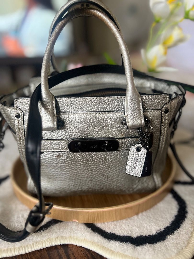 Coach Pebble Leather Metallic Silver Handbag (Category: Luxury Bags & Wallets) located in Lubao. Submitted by inna_segovia20 (Listing ID 1446411740, Image 1). Description: - Metallic silver Coach handbag - Limited Edition - Pebbled leather texture - Top zip closure - Front pocket with turn-lock detail - Interior zip pocket - Detachable crossbody strap included - Minor exterior marks visible (please check photos).