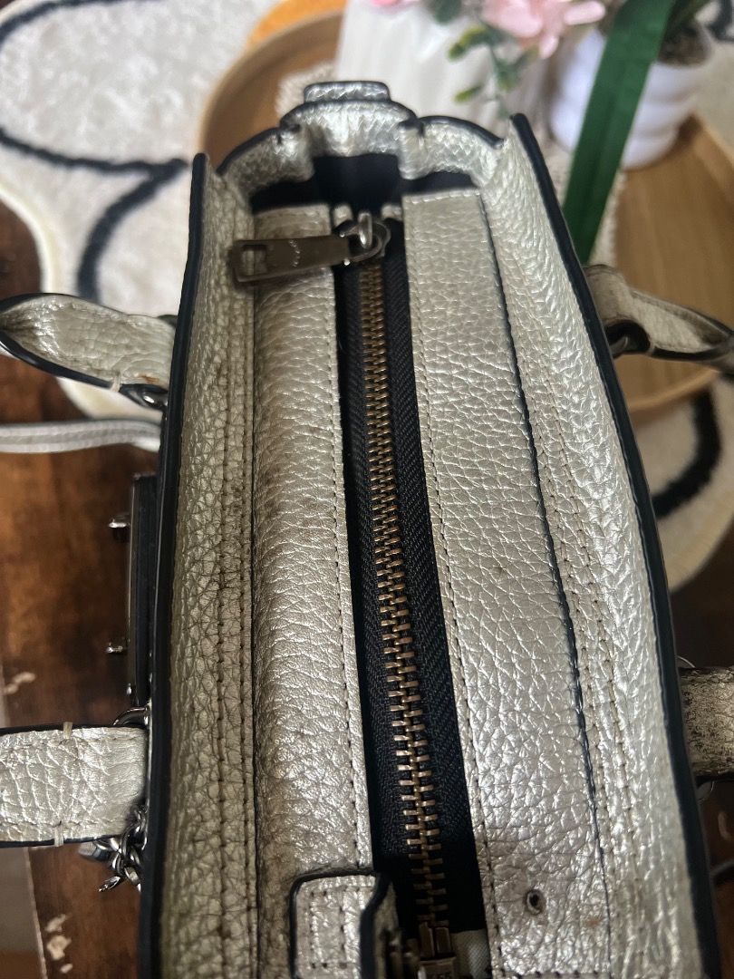 Coach Pebble Leather Metallic Silver Handbag (Category: Luxury Bags & Wallets) located in Lubao. Submitted by inna_segovia20 (Listing ID 1446411740, Image 3). Description: - Metallic silver Coach handbag - Limited Edition - Pebbled leather texture - Top zip closure - Front pocket with turn-lock detail - Interior zip pocket - Detachable crossbody strap included - Minor exterior marks visible (please check photos).