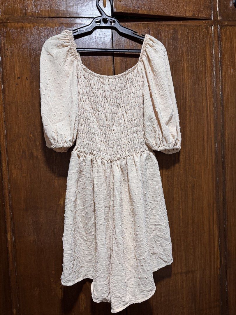 Cream Smocked Puff Sleeve romper (Category: Dresses) located in Quezon City. Submitted by KK_declutterluxx (Listing ID 1446443823, Image 1). Description: - Cream colored mini dress - Smocked bodice - Puff sleeves - Textured dot pattern fabric - Square neckline - Short length - Versatile for casual or night out - fits large to xl - used once Sf c/o buyer.