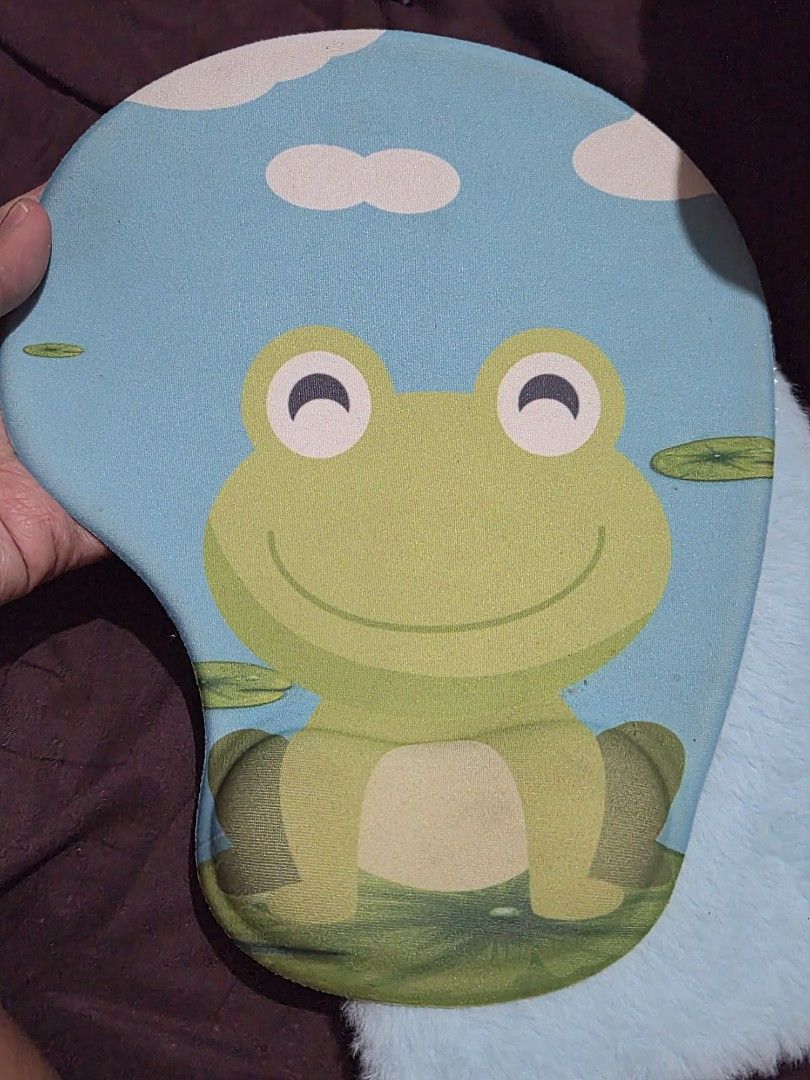 Cute Frog Wrist Rest Mouse Pad (Category: Mouse & Mousepads) located in Mandaue City. Submitted by chuchi152615 (Listing ID 1446512498, Image 1). Description: - Adorable frog design mouse pad - Built-in wrist rest for enhanced comfort - Features a blue background with lily pads and bubbles - Textured grip on the bottom to prevent slipping - Adds personality and fun to your desk setup.
