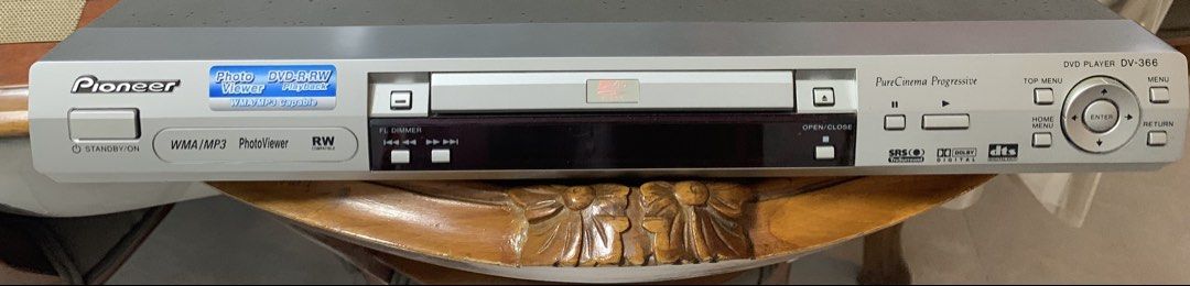 DVD player (Category: Entertainment Systems & Smart Home Devices) located in Singapore. Submitted by artistpicaso (Listing ID 1446359725, Image 1). Description: - Pioneer DVD Player DV-366 with remote control - Supports DVD, Photo, WMA, and MP3 playback - Features Photo/WMA/MP3 viewer - Reliable and in good working condition - Classic silver design.