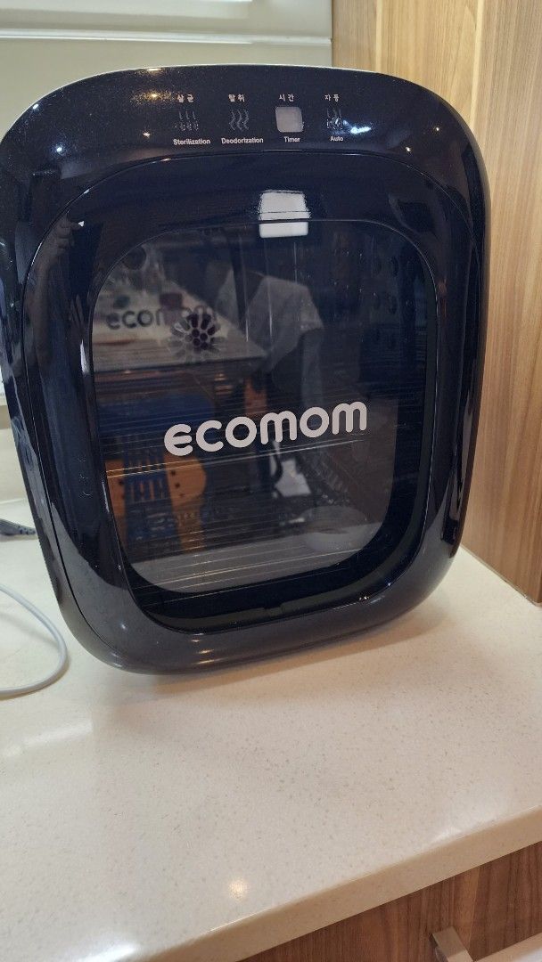 Ecomom Baby Bottle Sterilizer Dryer (Category: Breastfeeding & Bottle Feeding) located in Makati City. Submitted by carwtan90 (Listing ID 1446368037, Image 1). Description: - Ecomom Sterilizer and Dryer - Keeps baby bottles clean and dry - Sleek black and white design - Perfect for busy parents - Simple and easy to operate - Please check photos for detailed condition.