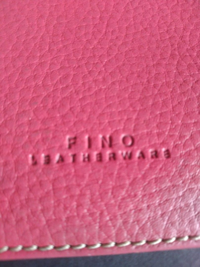 FINO LEATHERWARE Pink pebbled Leather Pouch (Category: Purses & Pouches) located in Pasig City. Submitted by aecollection03 (Listing ID 1446254121, Image 2). Description: - Genuine FINO LEATHERWARE pink pouch -8⅛"W×4"H - pebbled leather exterior with classic white stitching - Secure zipper closure - Interior lined with a stylish red and beige plaid fabric - Convenient small ring detail on the side - Ideal for keeping your essentials organized.
