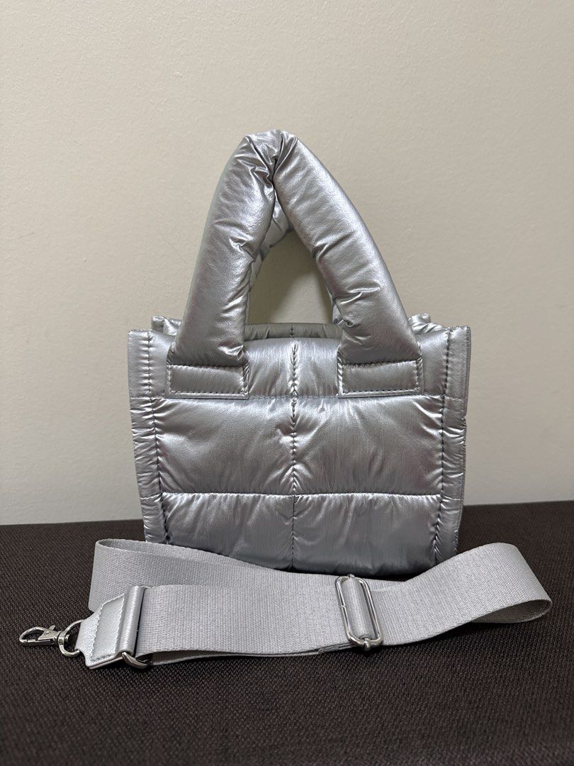 GU Silver Puffer Tote Bag (Category: Cross-body Bags) located in Quezon City. Submitted by msafer (Listing ID 1446396764, Image 1). Description: - Used twice then stored - Cool silver puffer tote bag - Shiny metallic finish - Magnetic snap closure - Detachable and adjustable shoulder strap - Spacious interior for essentials.