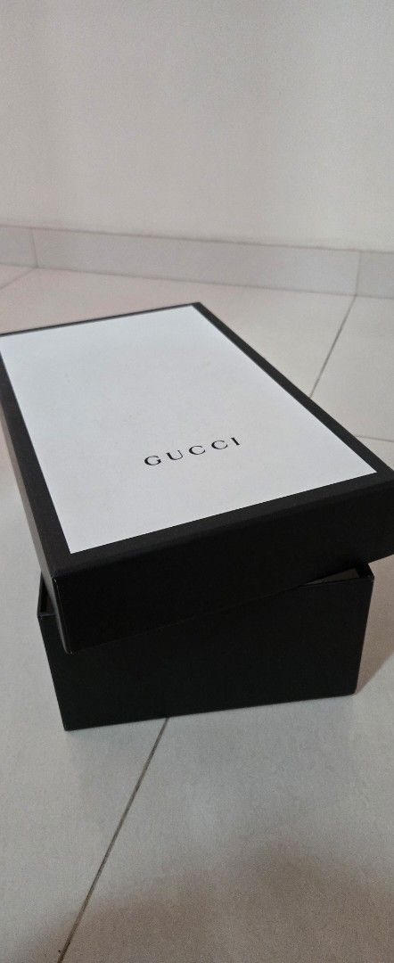 Gucci Box (Category: Bags & Wallets) located in Singapore. Submitted by nicky_9123 (Listing ID 1446356917, Image 1). Description: - Genuine Gucci box - Black with white lid - Ideal for storing small items - Perfect as a gift box - Clean and sturdy condition - Approx. [insert dimensions here if known].