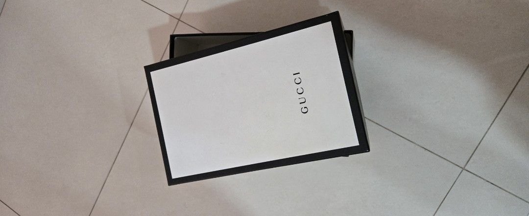 Gucci Box (Category: Bags & Wallets) located in Singapore. Submitted by nicky_9123 (Listing ID 1446356917, Image 2). Description: - Genuine Gucci box - Black with white lid - Ideal for storing small items - Perfect as a gift box - Clean and sturdy condition - Approx. [insert dimensions here if known].