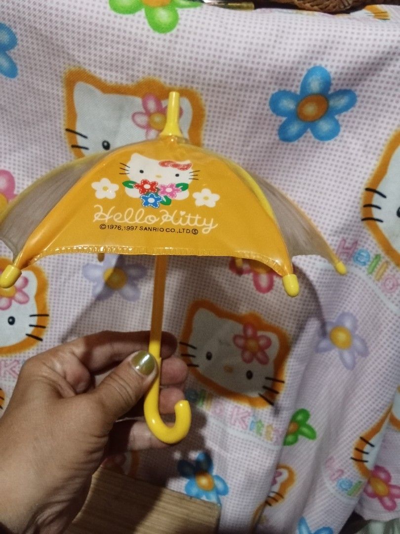 Hello Kitty Mini Umbrella (Category: Umbrellas) located in Bocaue. Submitted by marajapansurplus (Listing ID 1446460692, Image 1). Description: - Adorable yellow Kitty mini umbrella - Features cute flower designs - Bright yellow hook handle - Fun and easy for children to open and close.