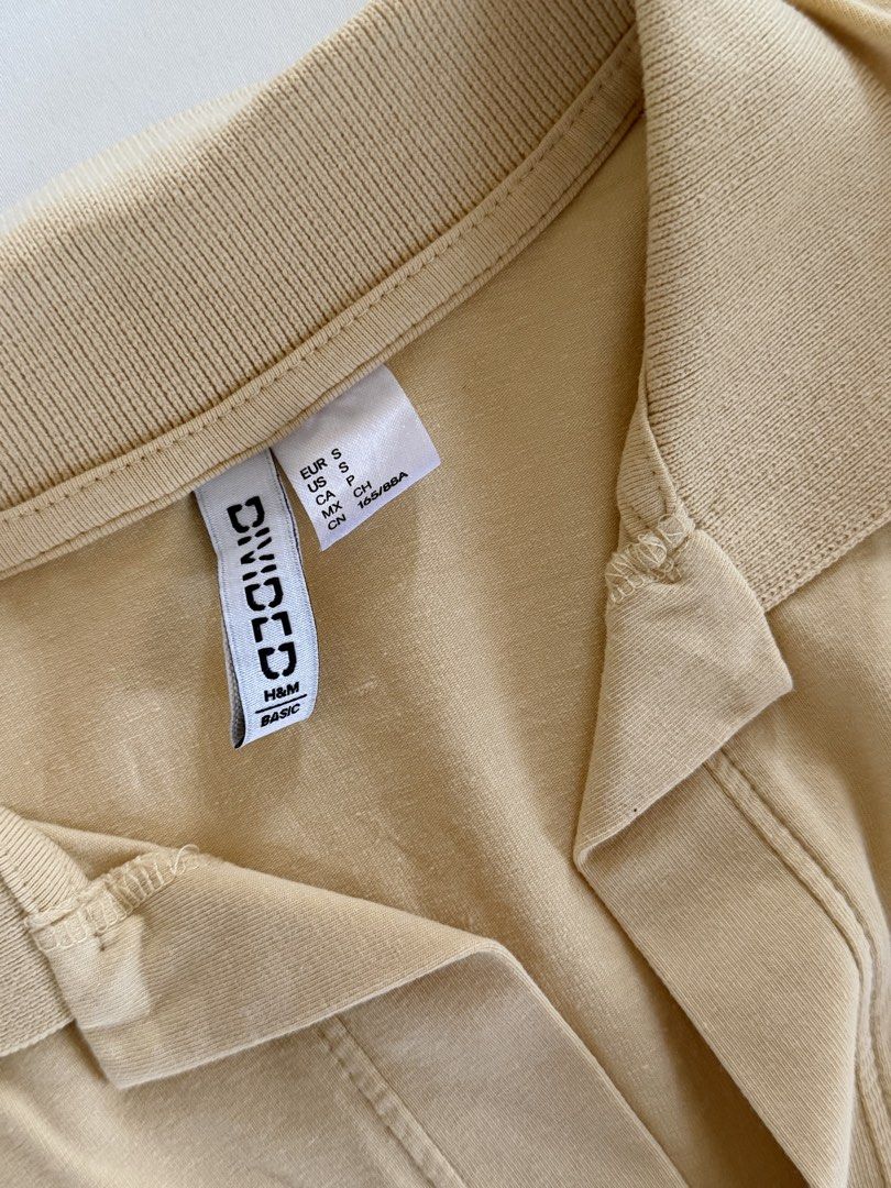 H&M Divided Beige Cropped Polo Shirt (Category: Shirts) located in Tanauan. Submitted by lovelavi (Listing ID 1446365907, Image 2). Description: Cropped polo shirt perfect for cover up while wearing kinis! Worn once only!.