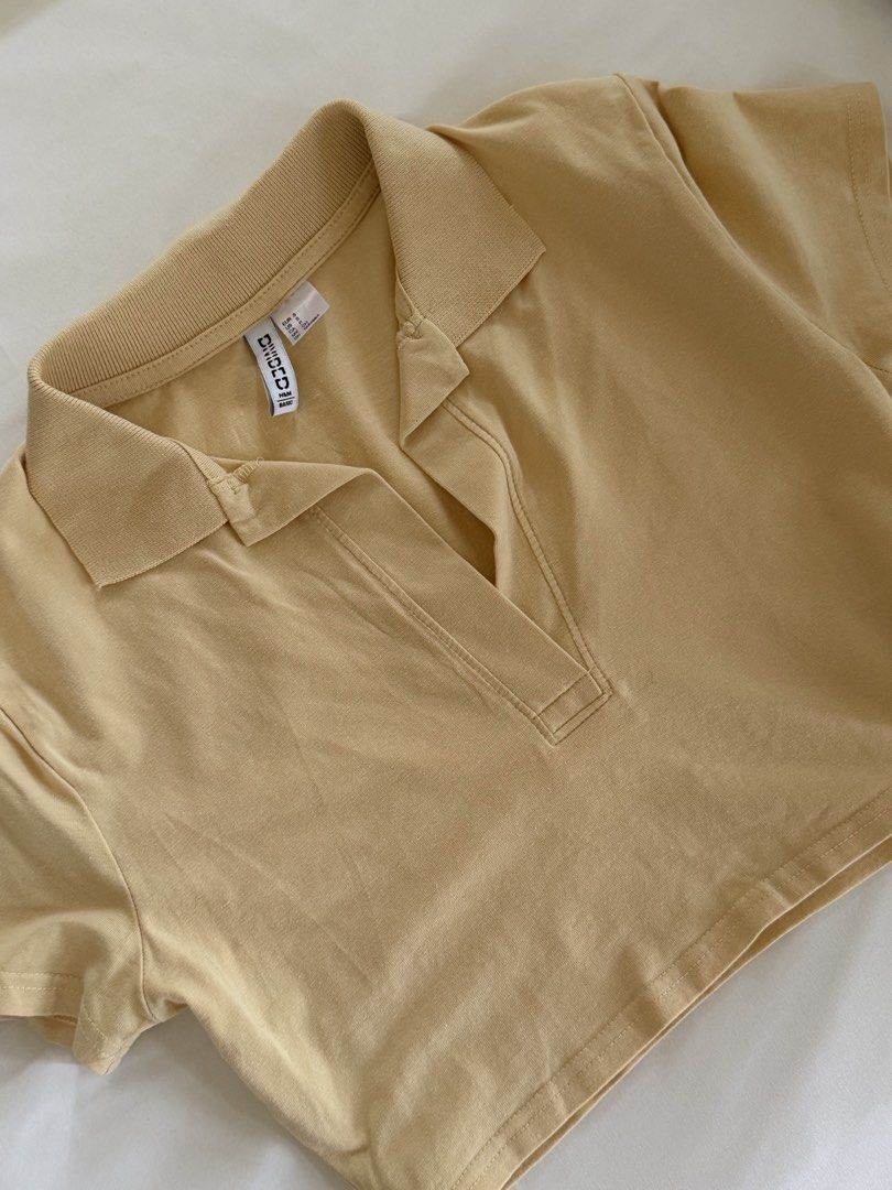H&M Divided Beige Cropped Polo Shirt (Category: Shirts) located in Tanauan. Submitted by lovelavi (Listing ID 1446365907, Image 1). Description: Cropped polo shirt perfect for cover up while wearing kinis! Worn once only!.