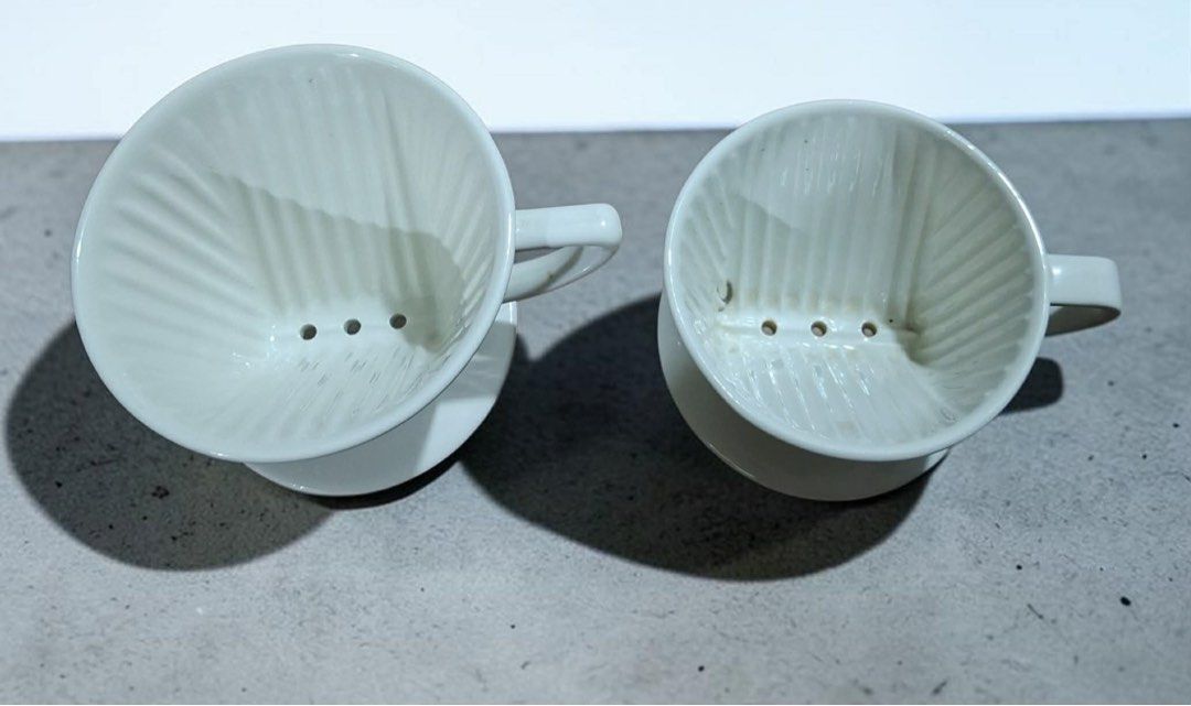Kalita Coffee Dripper (Category: Coffee & Tea Tableware) located in Pasig City. Submitted by stelala19 (Listing ID 1446503449, Image 1). Description: Kalita Coffee Dripper White ceramic Kalita 102 coffee dripper, designed to hold filters for brewing 2–4 cups of coffee. Has three drainage holes and internal grooves to ensure even water flow and coffee extraction. This specific model is made from traditional Japanese Hasami porcelain. Take 2 for 25