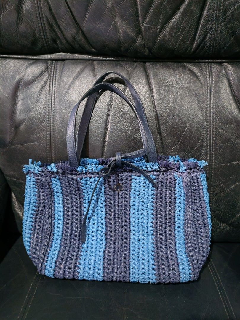 Kate Spade Striped Woven Tote Bag (Category: Tote Bags) located in Davao. Submitted by athenaprelovedph (Listing ID 1446413293, Image 1). Description: - Blue and navy striped woven tote bag - Genuine leather handles and trim - Secure drawstring closure - Interior zip pocket and slip pocket - Kate Spade logo inside - Spacious design, ideal for everyday or beach outings.
