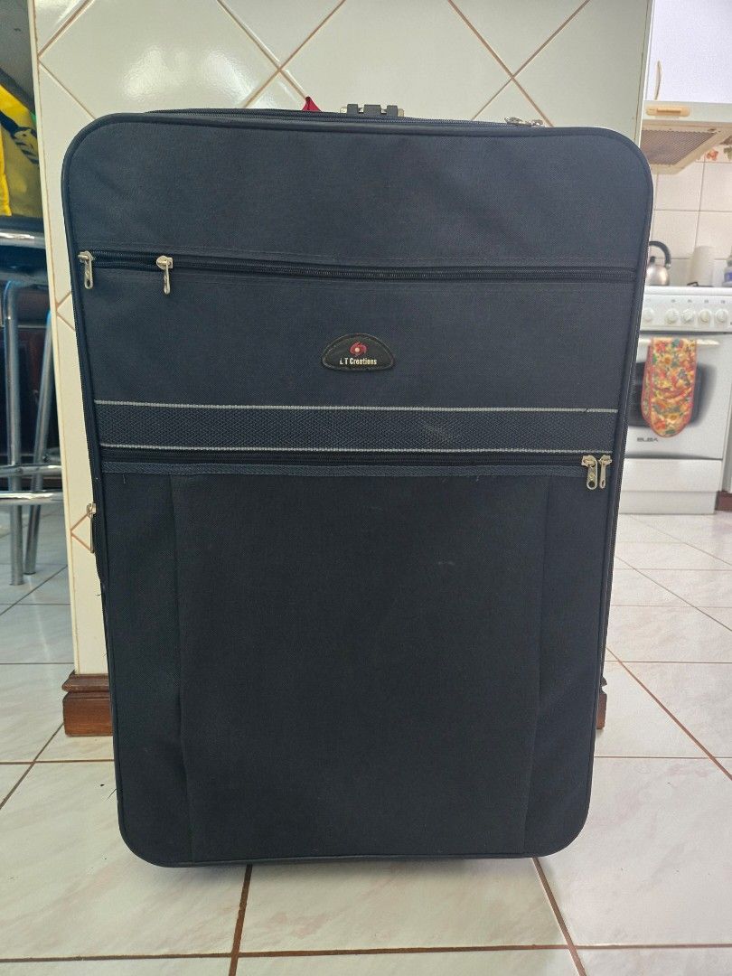 LARGE LT Creations Navy Blue Luggage with Combination Lock (Category: Luggage) located in Quezon City. Submitted by samcas (Listing ID 1446390874, Image 1). Description: Navy blue LT Creations suitcase with built-in combo lock. Sturdy handles and zippers. Organized interior. Perfect for your next trip! height: 27.5" width: 18" depth: 10.5" .