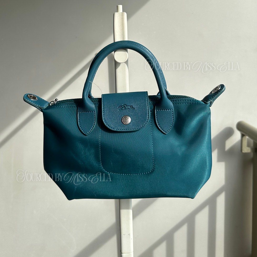 Longchamp Le Pliage Cuir Small Top Handle Bag Teal (Category: Luxury Bags & Wallets) located in Manila. Submitted by sourcedbymissella_ (Listing ID 1446485975, Image 1). Description: MESSAGE US FOR MORE INFO 💌 750 + shipping fee shouldered by buyer fixed price 🔒 onhand 👌🏻 With Strap 💃 - Teal Longchamp handbag - Small size, ideal for everyday essentials - Versatile carrying options: top handles and shoulder strap - Secure closure: zipper with