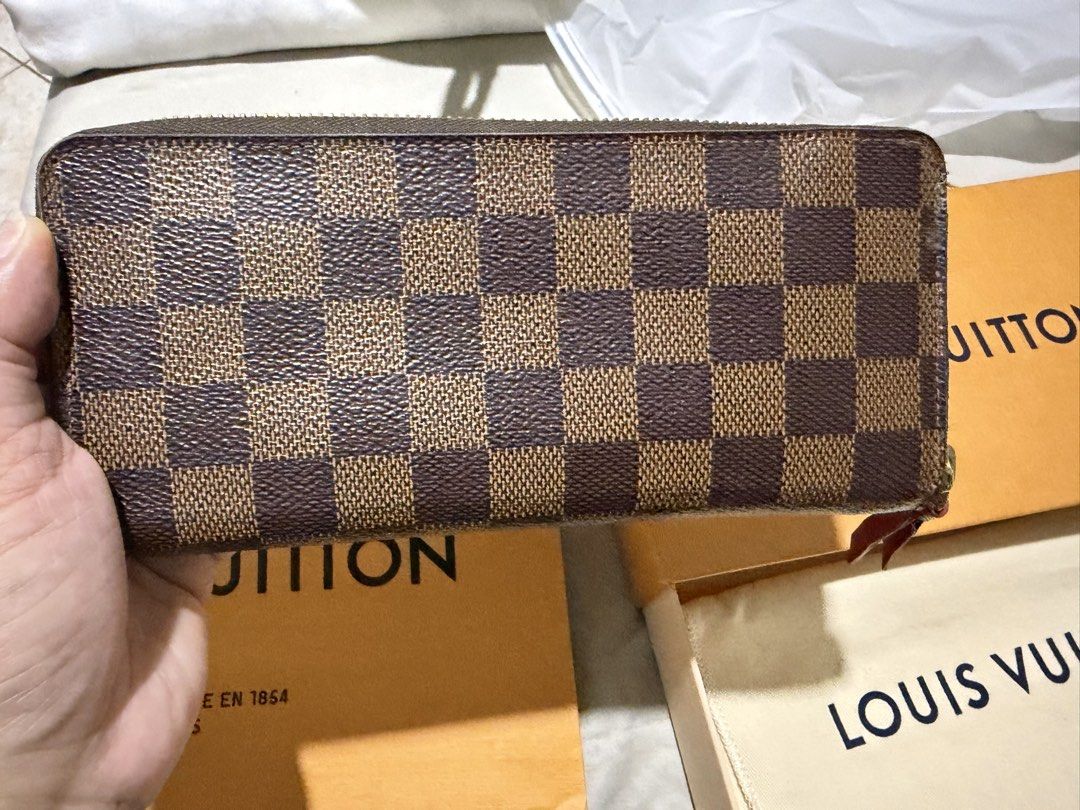 Authentic Louis Vuitton Damier Ebene Canvas Zippy Wallet (Category: Luxury Bags & Wallets) located in Cavite. Submitted by mcbfave (Listing ID 1446488647, Image 2). Description: - Authentic Louis Vuitton Clemence Wallet - Damier Ebene Canvas - Includes Original Box, Dust Bag, and Shopping Bag - Secure Zipper Closure - Ample Interior Space for Cards and Cash - Ideal for Everyday Use.